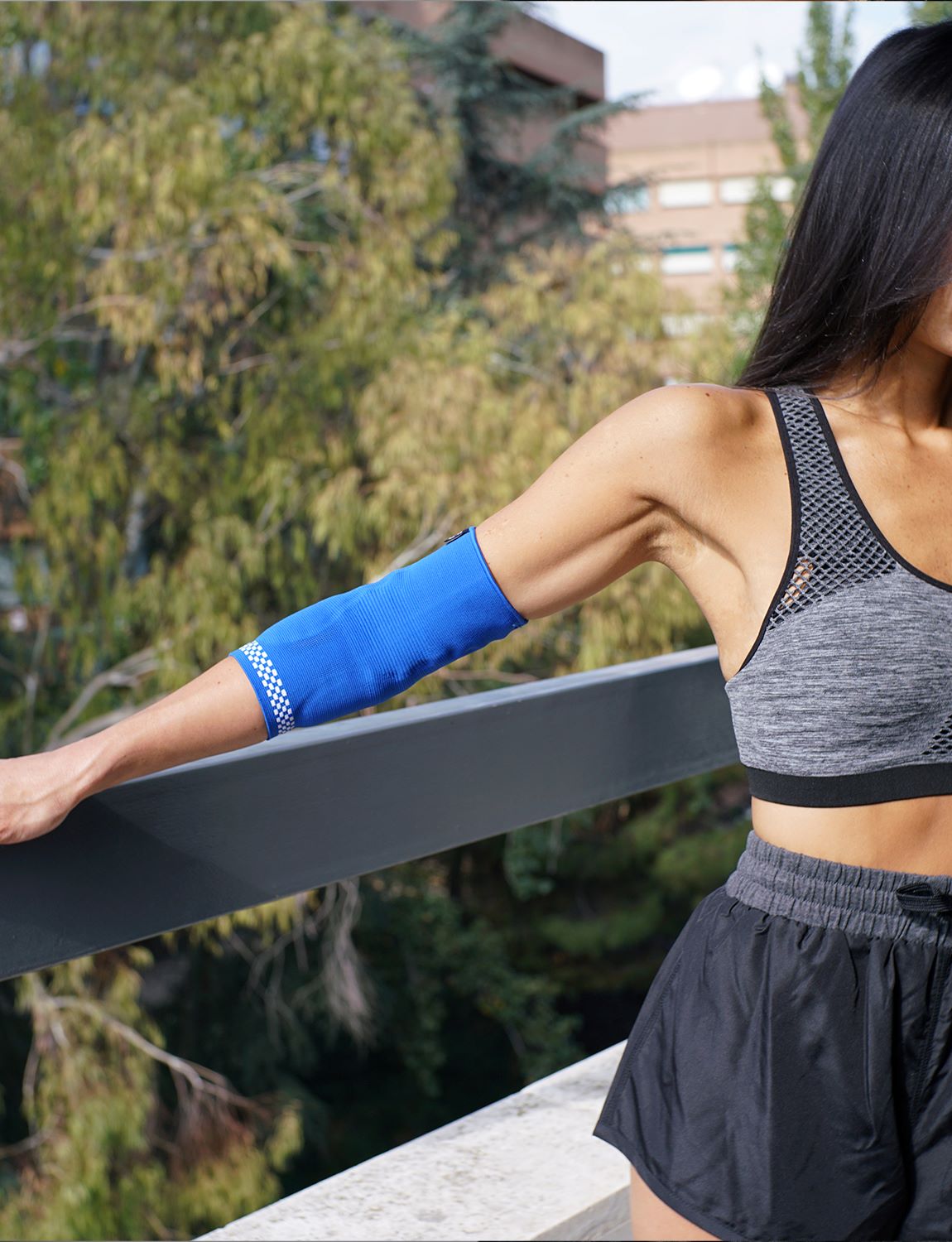 Woman wearing Neo G Airflow Plus Elbow Support with Silicone Joint Cushions on straight right arm 