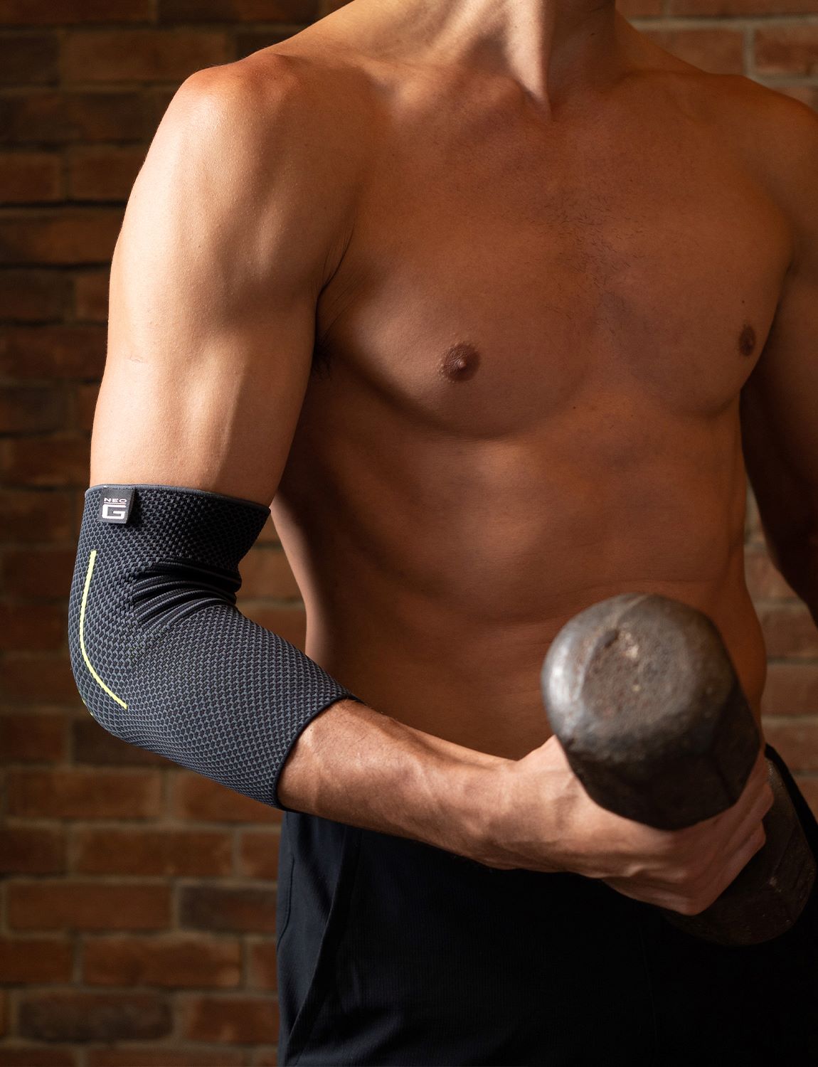 Man wearing Neo G Active Elbow Support facing front, lifting weights