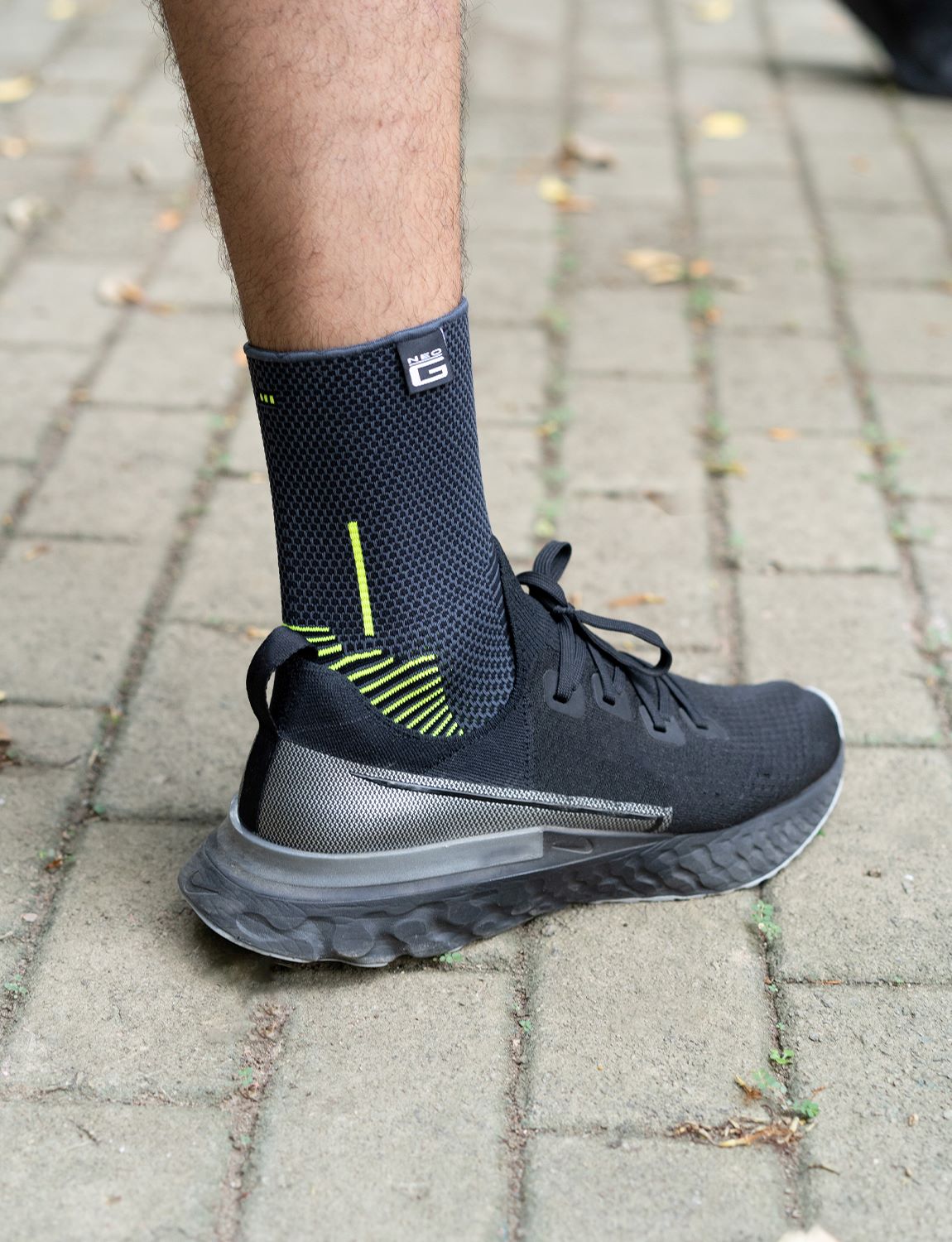 Foot wearing Neo G Active Ankle Support in sneaker